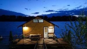 a cabin on a dock on a lake at night at Apartman na vodi in Belgrade +19 photos