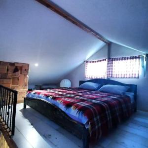 a bedroom with a large bed in a attic at Apartman na vodi in Belgrade