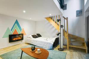 a living room with a bed and a fireplace at Large and calm flat in the heart of Lille - Welkeys in Lille