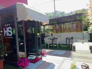 a restaurant with a patio with tables and chairs at Hotel Sereno in Sestri Levante
