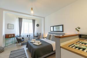 a bedroom with a bed and a living room at Polai Panorama Apartments with FREE Parking in Pula