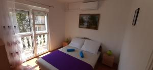 Posteľ alebo postele v izbe v ubytovaní Major apartman