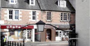 a street light in front of a brick building at City Centre Cottage in Inverness