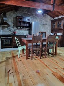 kuchnia z drewnianym stołem i krzesłami w pokoju w obiekcie Casa da Mimi w mieście Soajo