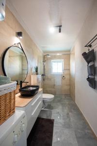 a bathroom with a sink and a toilet and a mirror at Apartment Zora in Trogir