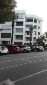 a parking lot with cars parked in front of a building at Apartamento con vistas al puerto deportivo Las Fuentes in Alcossebre