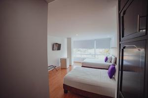 Voodi või voodid majutusasutuse Hotel Metropolis Plaza Cali toas
