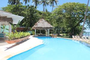 a pool at the resort with chairs and a gazebo at Mango Bay Resort in Namatakula