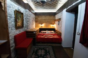 a room with a bed and a couch in it at Guesthouse Mele in Gjirokastër