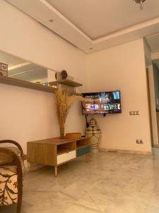 a living room with a tv on the wall at Holiday signature in Marrakech
