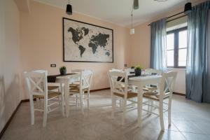 a dining room with white tables and white chairs at Gerosa Guest House in Lamezia Terme +19 photos