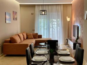 a living room with a couch and a table at TOURISTS RESIDENCE in Vlorë