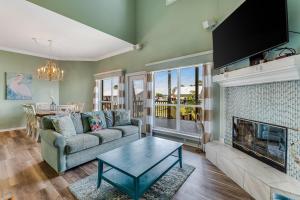 a living room with a couch and a fireplace at Lagoon Luxury in Gulf Shores