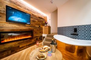 a living room with a fireplace and a tv at Craig's Suites in Windermere