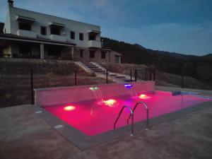a swimming pool with pink lights in a building at Piedra del Tesoro in Riópar