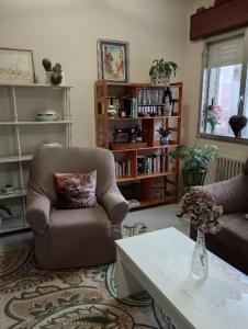 a living room with a chair and a coffee table at Casa Pepa in Cambados