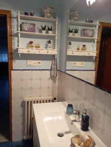 a bathroom with a white sink and a mirror at Casa Pepa in Cambados