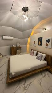 a large bed in a room with a ceiling at Kabak Freedom Deluxe Hotel in Faralya