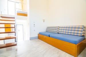niebieskie łóżko w pokoju ze schodami w obiekcie Orestis Hotel Sea View Apartments w Stalós +37 zdjęć