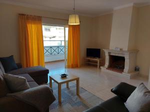 a living room with a couch and a fireplace at Apartamento Sunny Velamar in Patroves