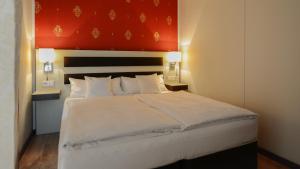 Postel nebo postele na pokoji v ubytování Hotel Nordhausen