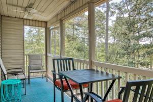 a screened in porch with a table and chairs at Pinehurst 14-I in Pawleys Island