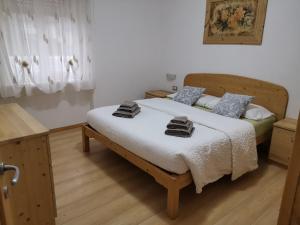 a bedroom with a bed with two towels on it at Appartamenti Casa Prandel in Levico Terme