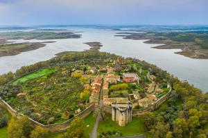 an aerial view of a castle next to a river at Casa Rural ARBEQUINA & Otoño MÁGICO in Casas del Monte +35 photos