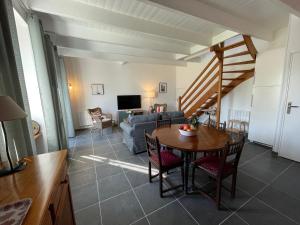 a living room with a table and a couch at Gites La Ville Pain in Cancale