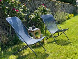 two chairs and a table in the grass at Gites La Ville Pain in Cancale +9 photos