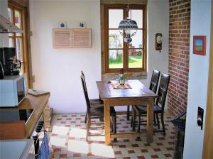 a kitchen with a table and chairs in a room at Fischerhaus Godewind 60 qm in Altwarp +36 photos