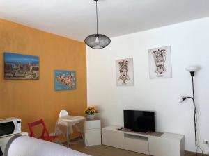 a bedroom with a bed and a tv on a wall at Casa Peppino in Letojanni