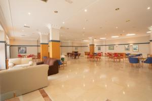 a large room with chairs and tables and chairs at Hotel Bracamonte in Peñaranda de Bracamonte