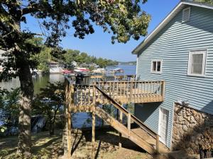 a deck on the side of a house at Cozy Lake Cabin Dock boat slip and lily pad in Lake Ozark