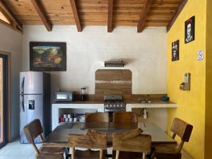 a kitchen with a table and a refrigerator at Los Pirineos in Mazamitla