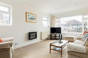 a living room with a couch and a tv at Beach Retreat in Bournemouth