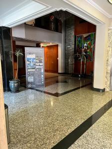 a lobby with a sign in the middle of a building at Bristol Hotel in Buenos Aires