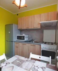 a kitchen with a refrigerator and a microwave at Noclegi Malta Poznań in Poznań