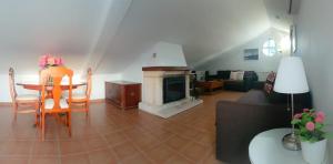 a living room with a table and a fireplace at El Sueño del Bosque in El Bosque