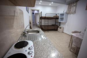a kitchen with a sink and a bunk bed at Villa Bel Passo Apartments in Kefalos +37 photos