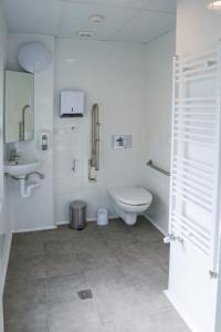 a white bathroom with a toilet and a sink at ATERPE KANPEZU HOSTEL in Santa Cruz de Campezo