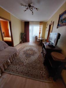 a bedroom with a bed and a tv on a table at Apartment on Voli Avenue 21 in Lutsk