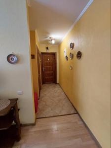 a hallway with a wooden door in a room at Apartment on Voli Avenue 21 in Lutsk