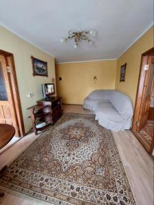 a bedroom with a bed and a rug at Apartment on Voli Avenue 21 in Lutsk