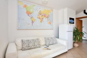 - un salon avec un canapé blanc et une carte murale dans l'établissement Casa Vacanze Mameli, à Bari Sardo