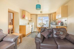 ein Wohnzimmer mit Couch und Küche in der Unterkunft Hillymouth in Ilfracombe + 9 Fotos