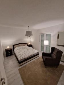 a bedroom with a bed and a chair at Uvac lake "FF" in Sjenica