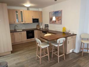 a kitchen with a wooden table and chairs at Haberstraße 4A Neumünster in Neumünster