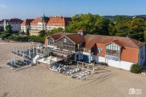 an overhead view of a building with tables and chairs at Park in Sopot