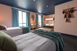 a bedroom with two beds and a room with a bed sqor at Roamer St Kilda - formerly Selina St Kilda Melbourne in Melbourne